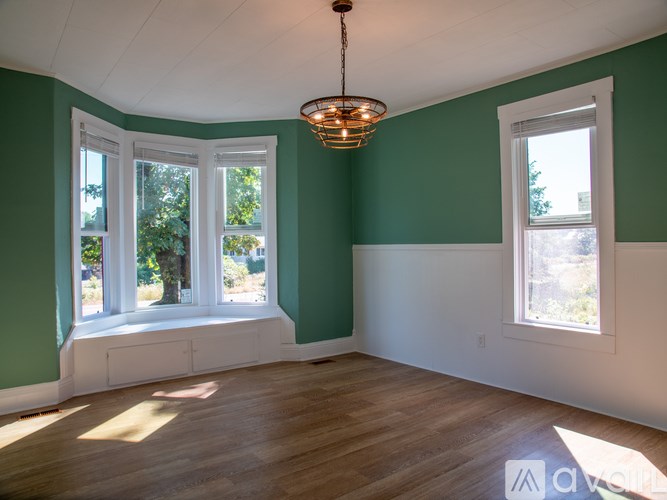 A room with green walls and wooden floors.