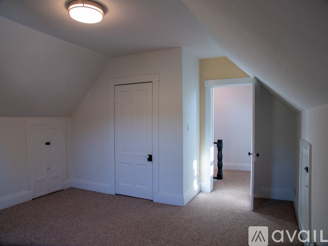 A room with a carpeted floor and white walls.