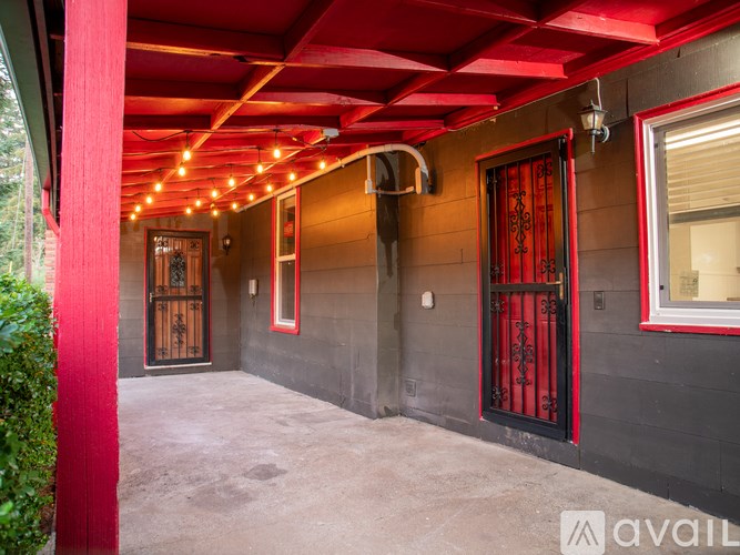 A red and black building with a red pole on the left.