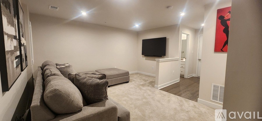A living room with a couch and a television.