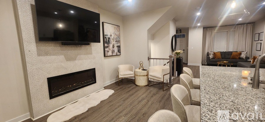 A modern living room with a fireplace and a television mounted on the wall.