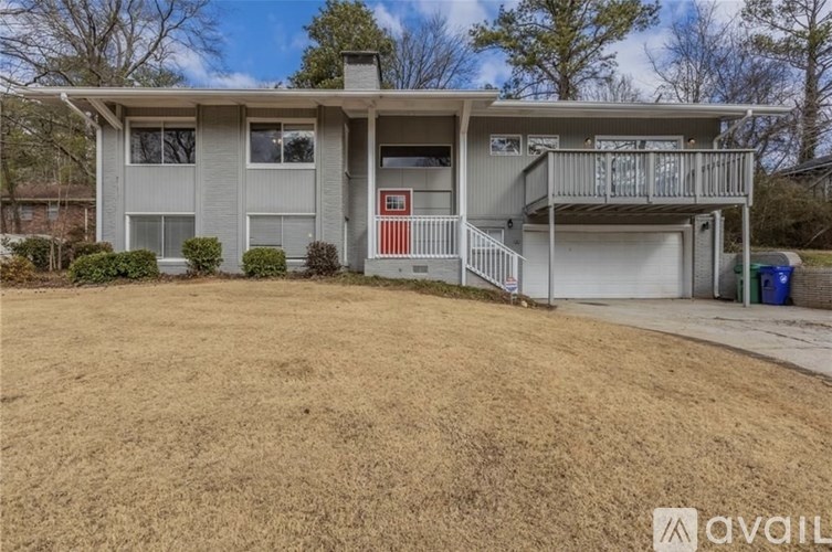 A two-story house with a garage and a balcony.