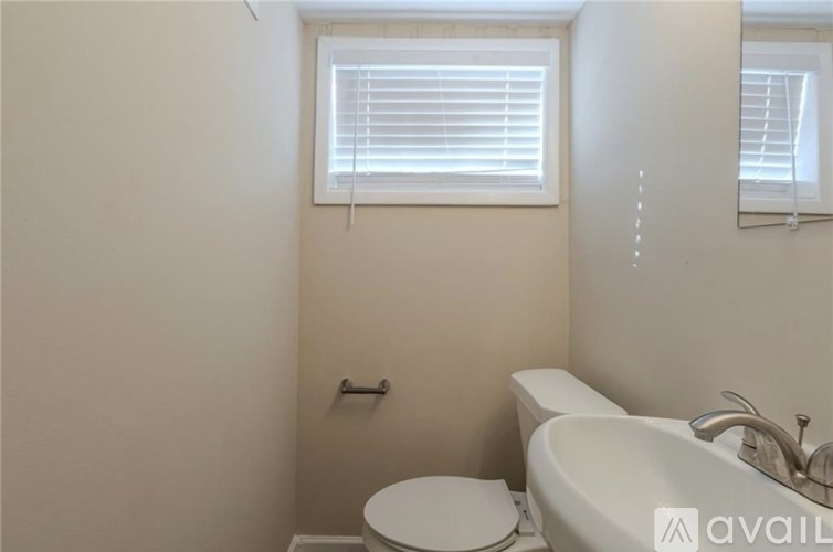A white toilet and sink in a bathroom.