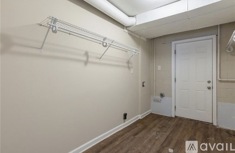 A house with a grey siding and a white porch.