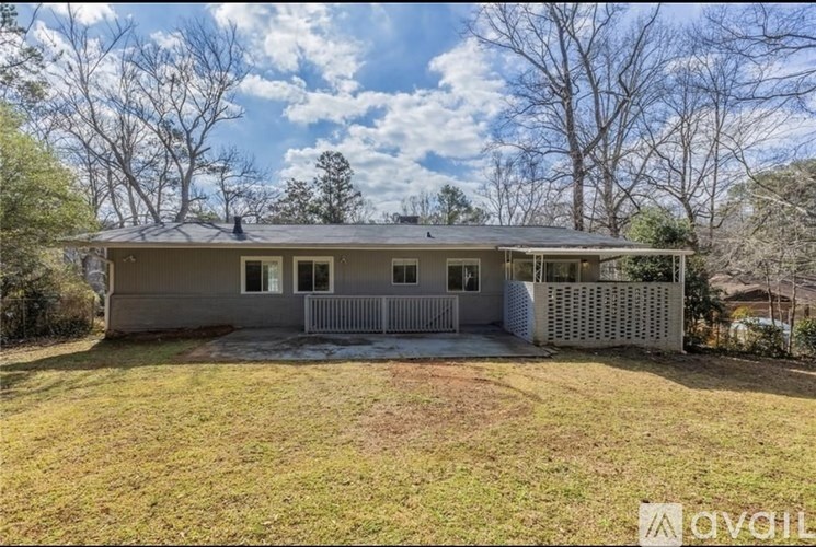 A house with a white picket fence is for sale.