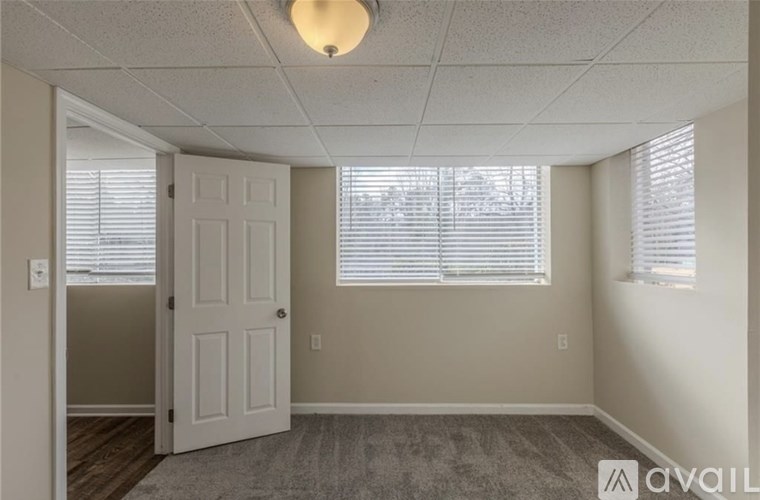 A room with a door, window, and carpet.