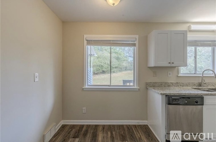 A kitchen with a window and a dishwasher.