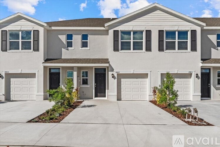 A row of houses with the first one having a grey front door.