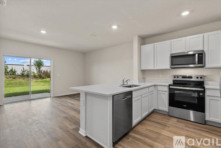 A kitchen with white cabinets and stainless steel appliances.