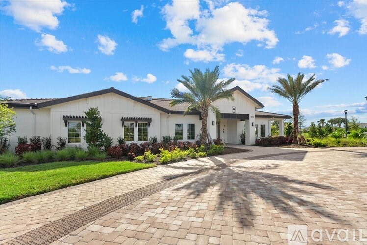 A white house with a driveway in front of it.