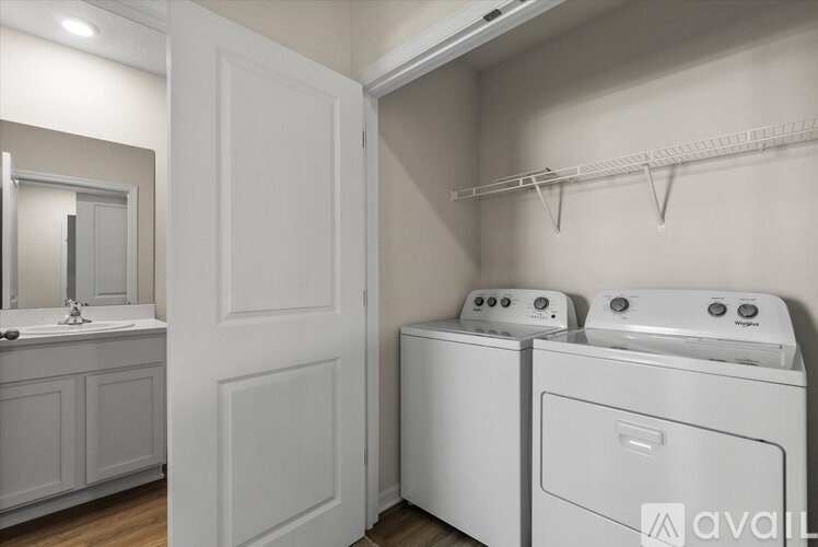 A white laundry room with a washer and dryer.