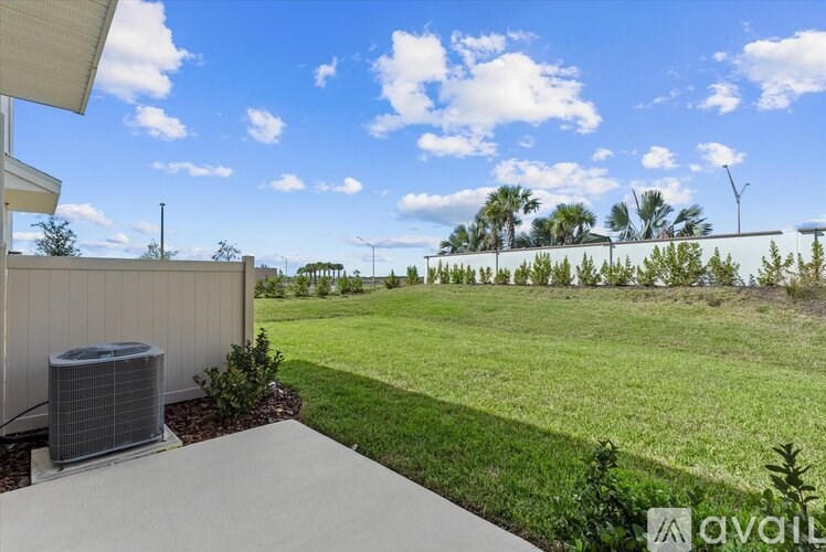 A sunny day with a clear blue sky and a grassy field.