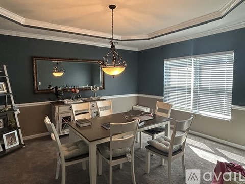 A dining room with a table set for six.