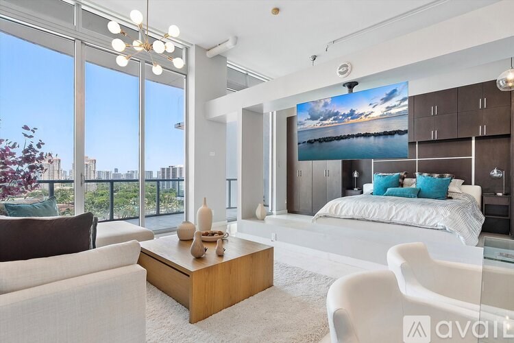A modern living room with a large window overlooking the city.