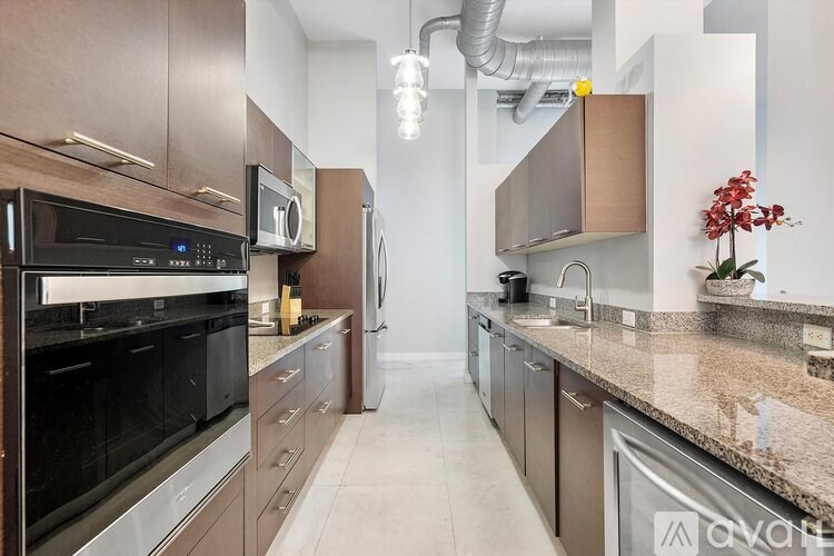 A kitchen with a black oven and a black fridge.