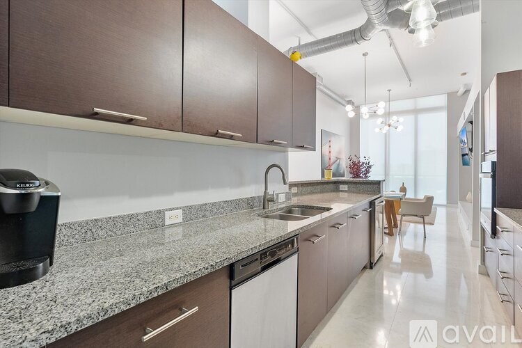 A kitchen with brown cabinets and a granite countertop.