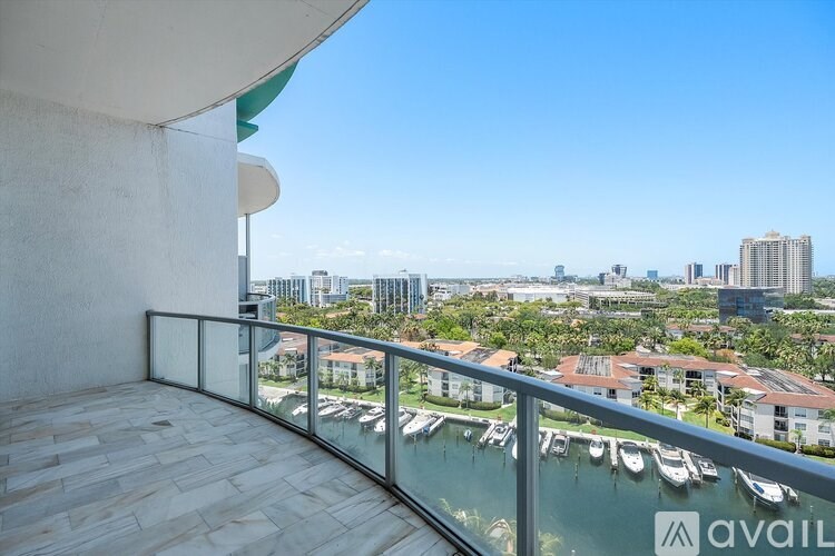 A balcony with a view of boats and buildings.