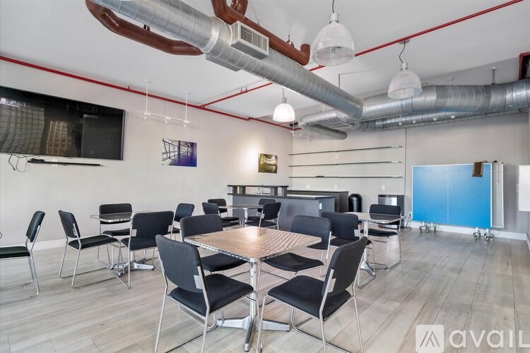 A conference room with a long table surrounded by chairs.