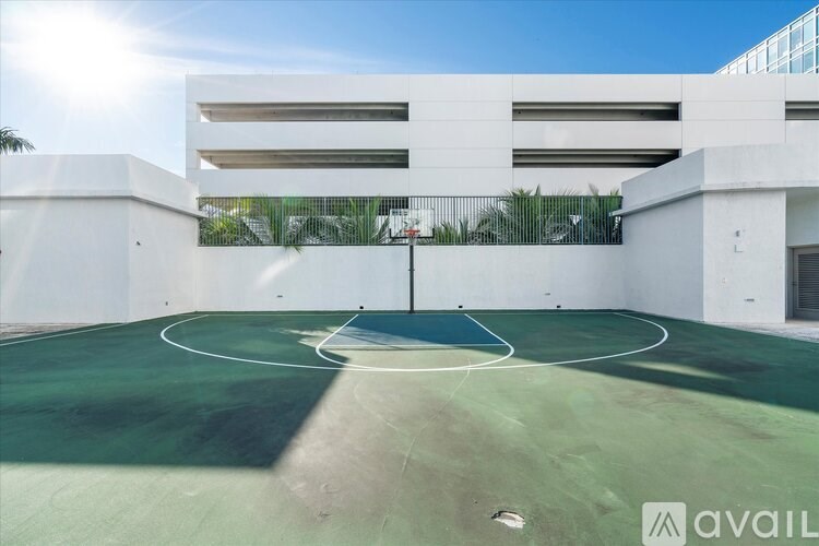 A basketball court is located in a parking garage.