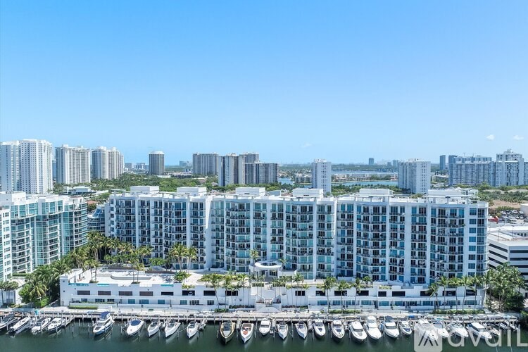 A row of high-rise buildings with a marina in the foreground.