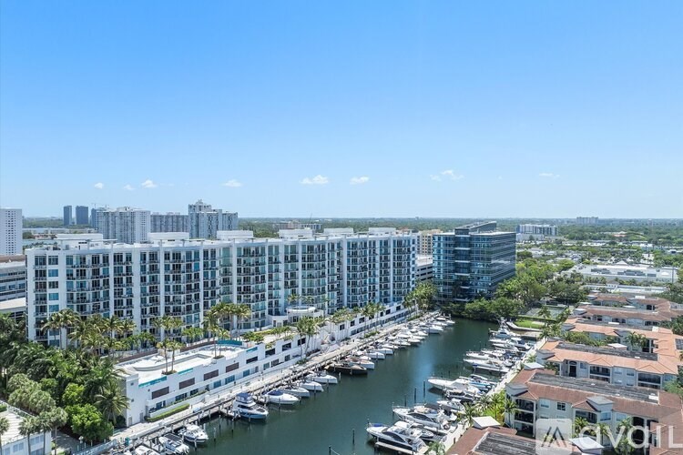 A marina with boats and buildings in the background.
