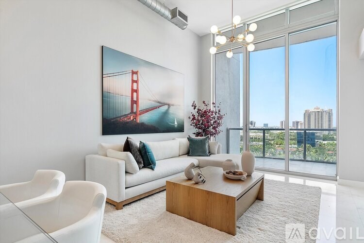 A living room with a large painting of the Golden Gate Bridge on the wall.