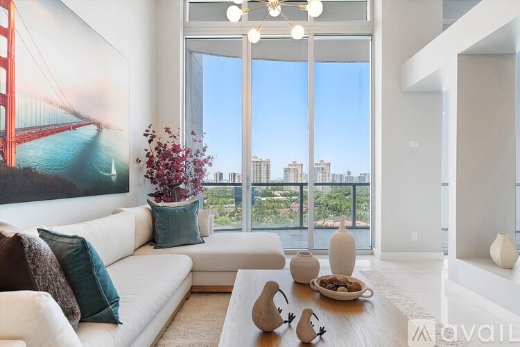 A living room with a large window overlooking the city.
