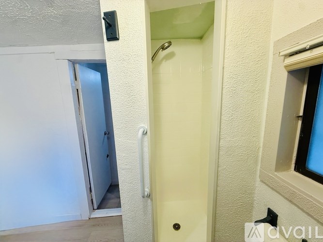 A white door with a handle and a lock is open.