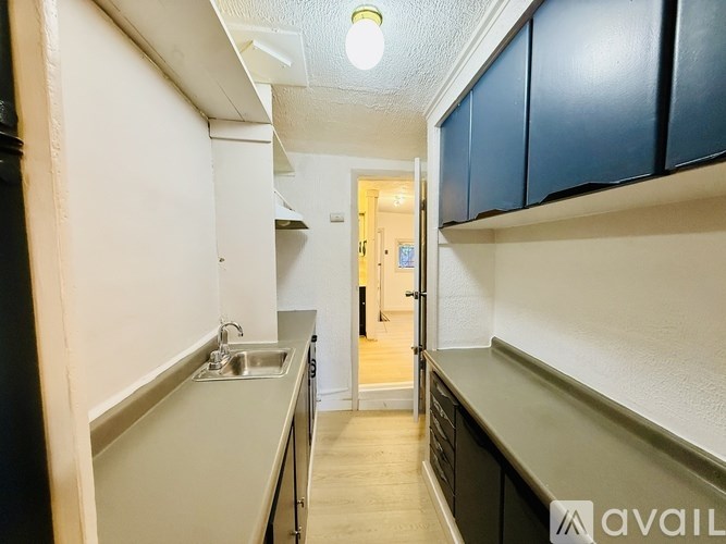 A kitchen with a sink and cabinets.