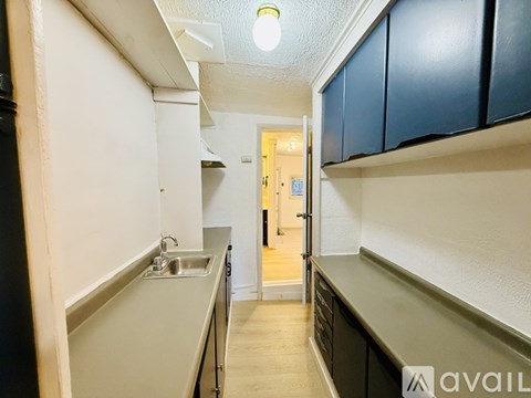 A kitchen with a sink and cabinets.