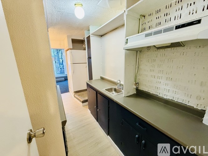 A kitchen with a sink and cabinets.