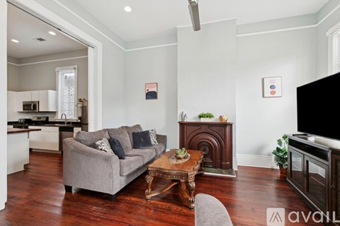 A living room with a grey couch and a wooden coffee table.