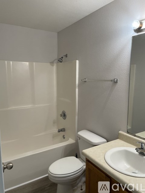 A bathroom with a toilet, sink, and bathtub.