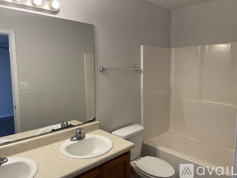 A bathroom with a sink, toilet, and bathtub.