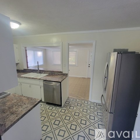 A kitchen with a dishwasher and a refrigerator.