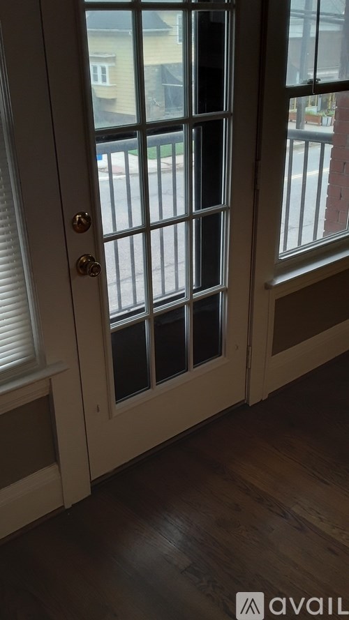 A white door with a window on the side.