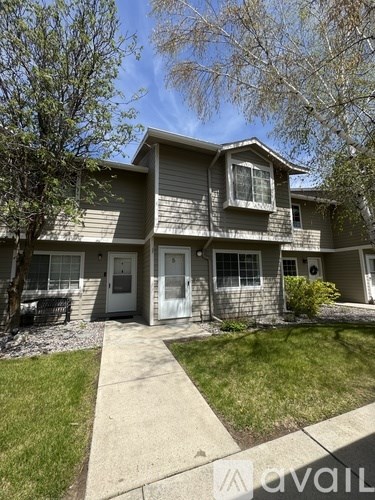 A two-story house with a white door and windows.