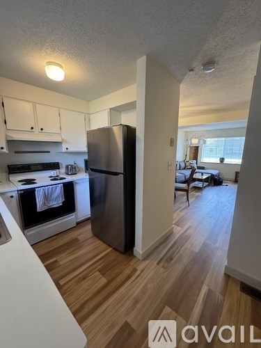 A kitchen with a refrigerator, stove, and oven.