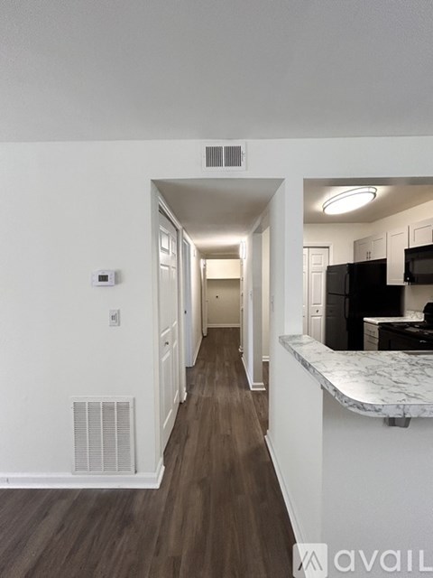 A long hallway with a kitchen area on the right.