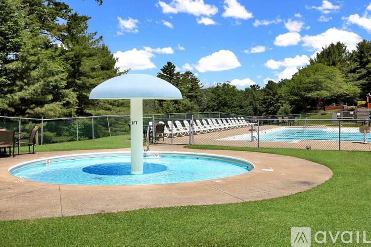 A pool with a blue umbrella and a sign that says "FREE".