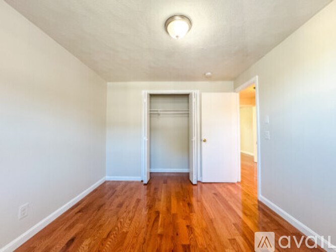 A room with wooden floors and white walls.