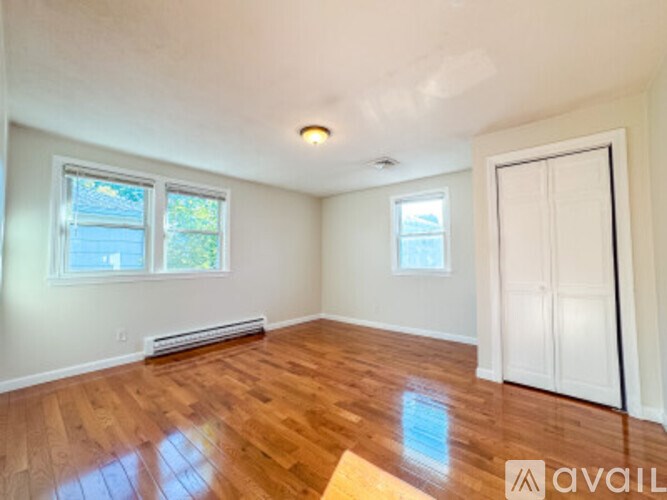 A room with wooden floors and a white door.