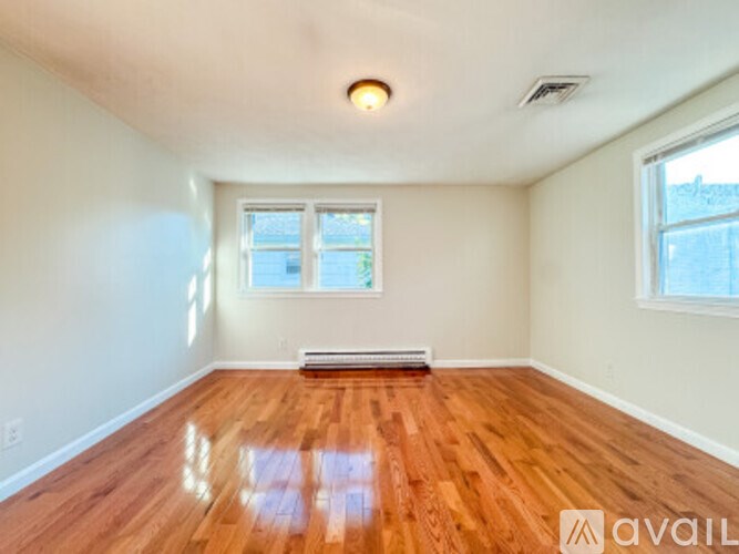 A room with wooden floors and a window.