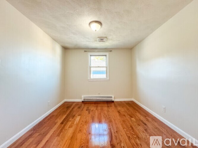A room with wooden floors and a window.