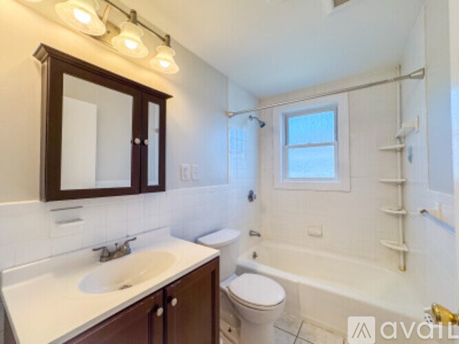 A bathroom with a white sink and a white toilet.