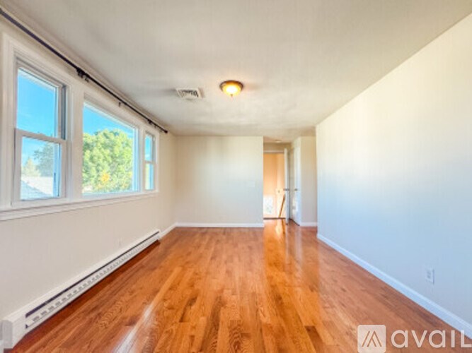 A room with wooden floors and white walls.