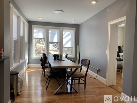 A dining room with a table and chairs.