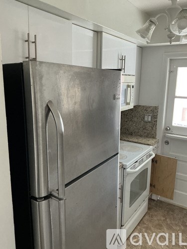 A stainless steel refrigerator in a kitchen.