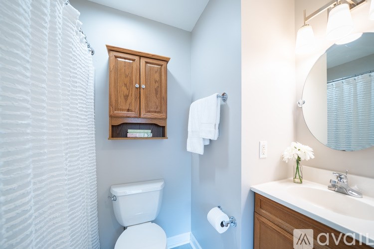 A white toilet sits next to a white sink in a bathroom.