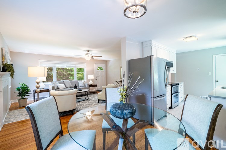 A modern kitchen with a glass table and chairs.